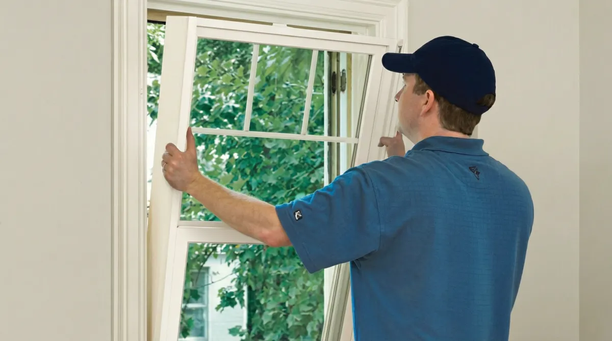 Professional contractors performing a residential window insulation and replacement service in Jackson, MS